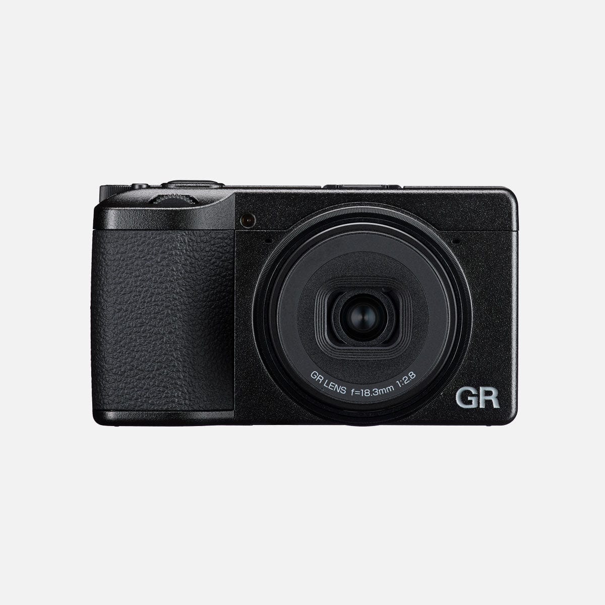 Fotocamera compatta Ricoh GR IV nera vista di fronte con l'obiettivo esteso, la scritta GR LENS f=18.3mm 1:2.8 sulla ghiera e il logo GR sul frontale